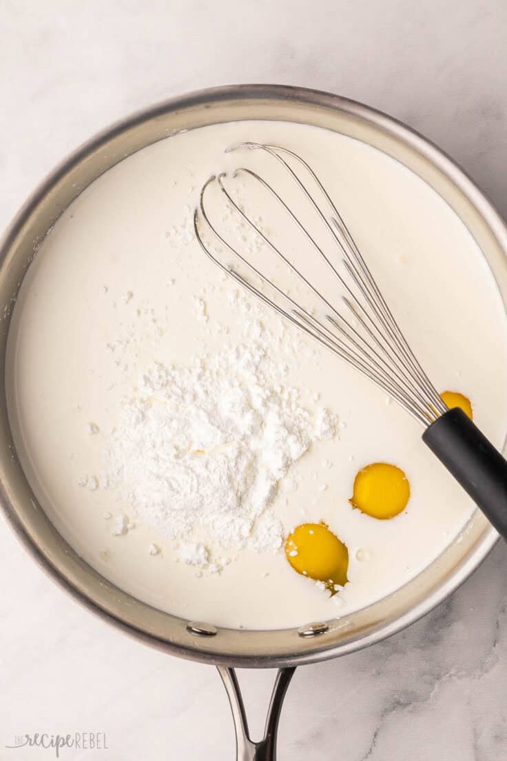 unmixed wet ingredients in pan with whisk.
