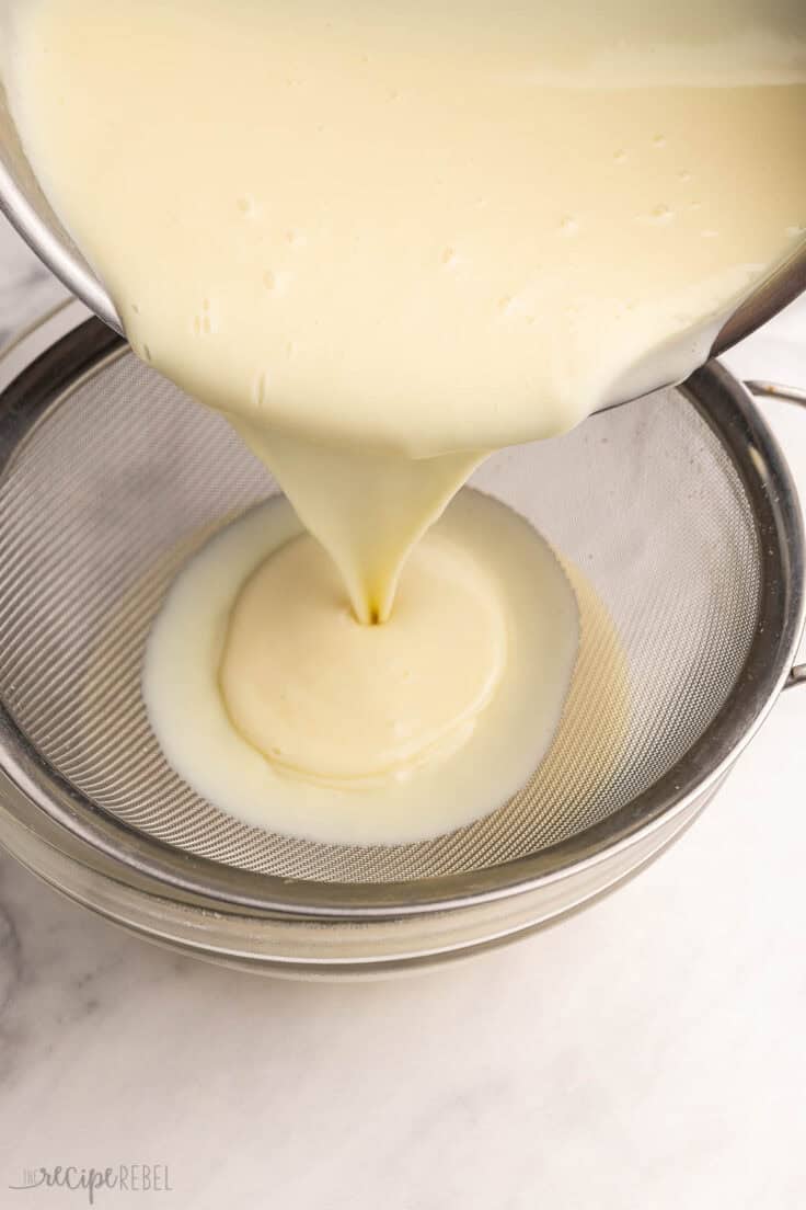 sauce being poured into strainer over bowl.
