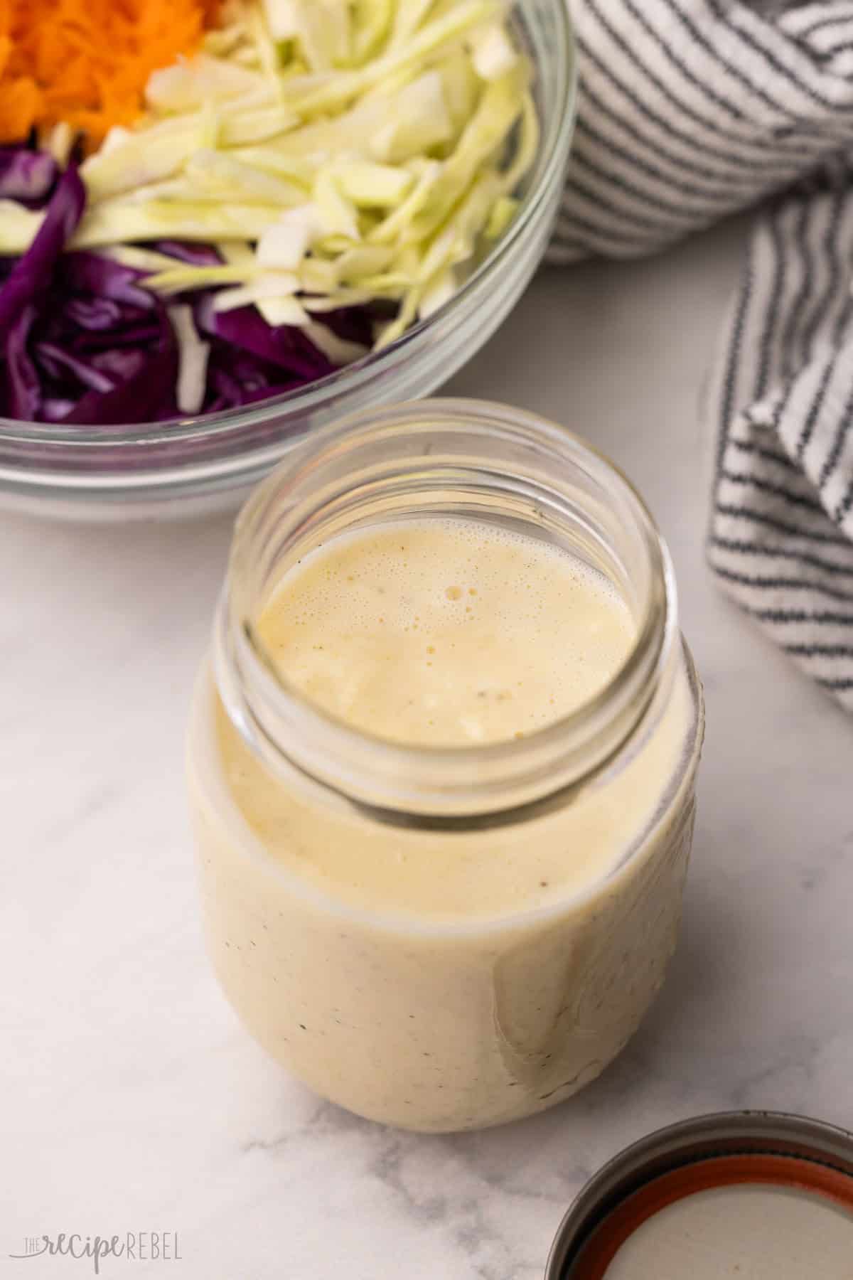 a jar filled with coleslaw dressing.