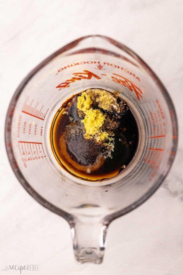 sauce ingredients added to glass measuring cup.