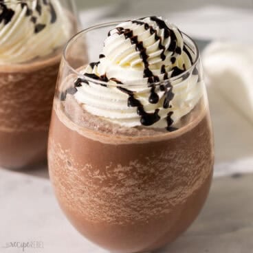 a glass of frozen hot chocolate topped with whipped cream.