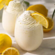 a lemon slice on the side of a glass of frozen lemonade.