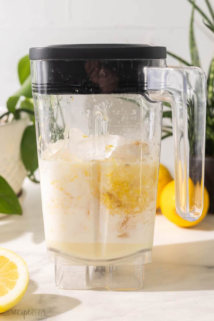 a blender filled with ingredients needed for frozen lemonade.