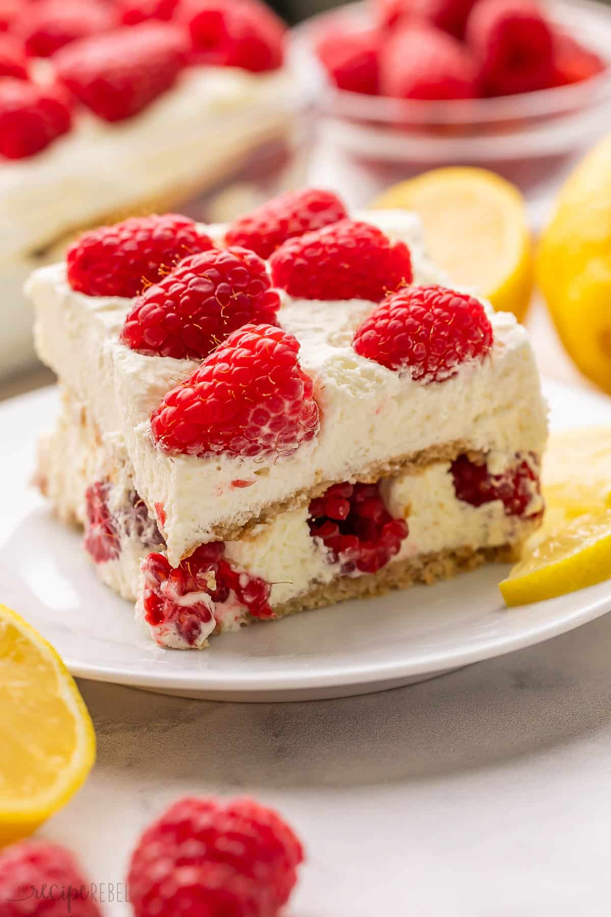 a piece of lemon raspberry icebox cake on a white plate.
