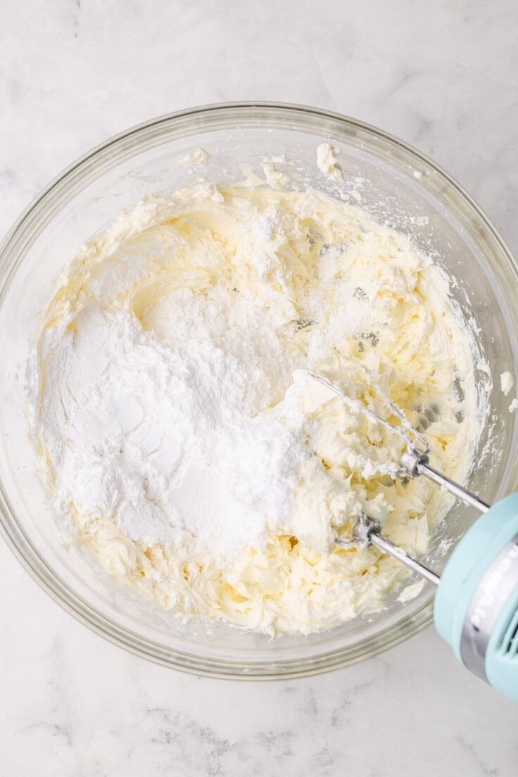 powdered sugar added to bowl of beaten cream cheese.