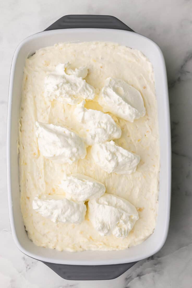 whipped cream added to top of pineapple dessert.