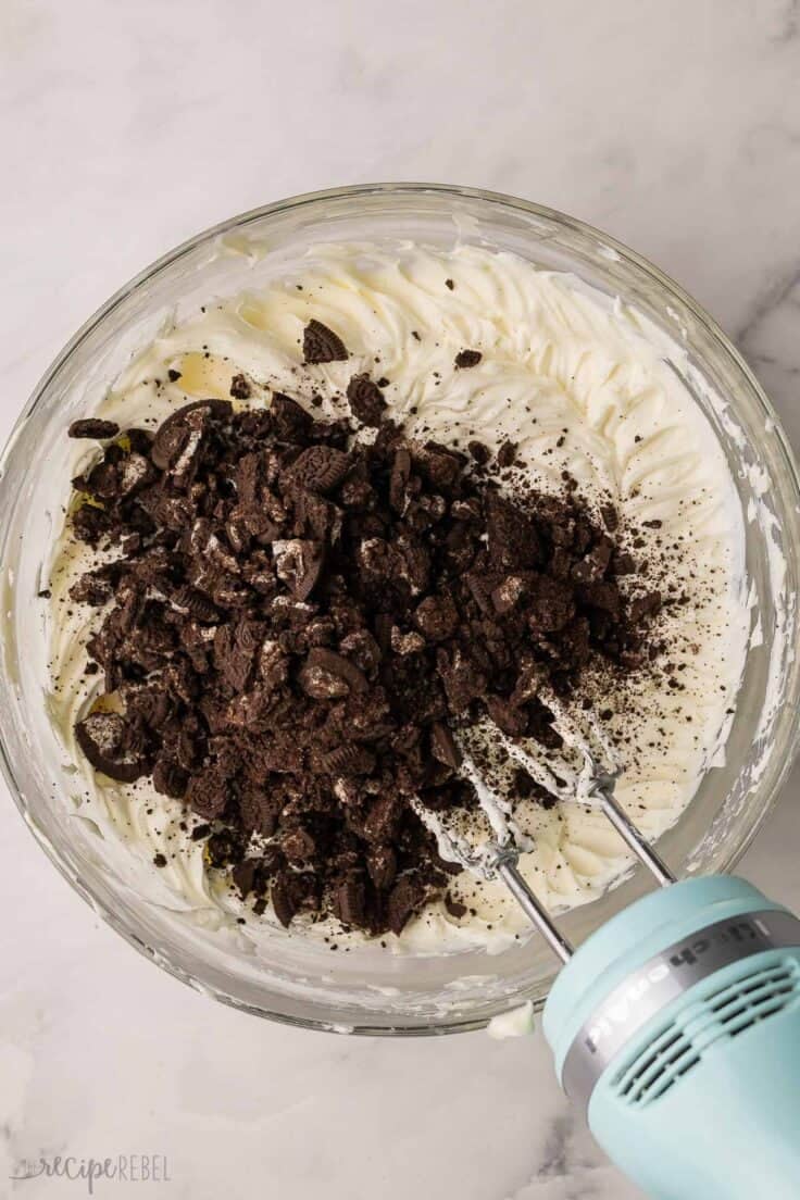 crushed oreos added to bowl of mixed ingredients.