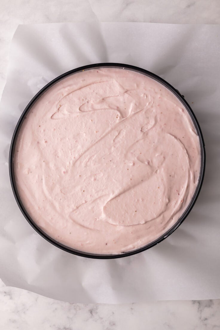 cheesecake spread into pan ready to be chilled.