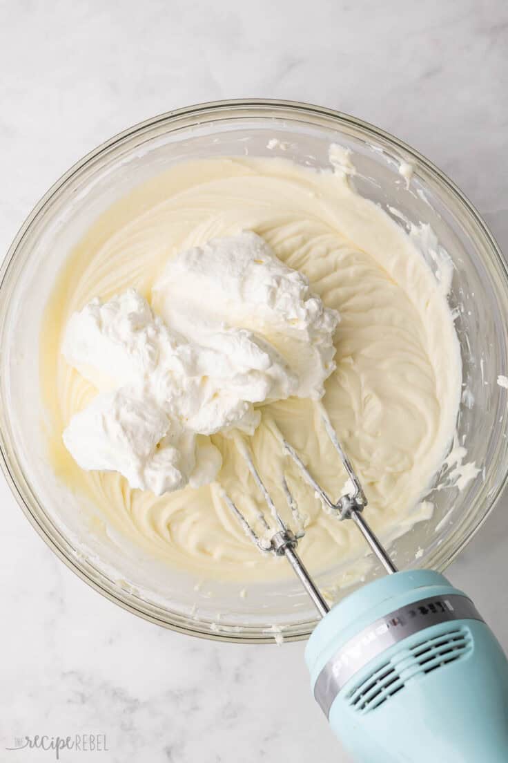 whipped cream added to bowl of cream cheese mixture.