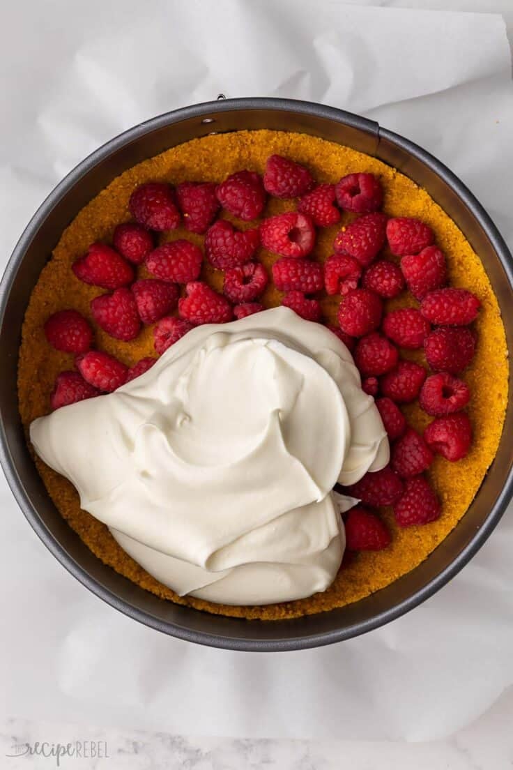 raspberries added on top of crust in pan with cream cheese mixture poured on top.