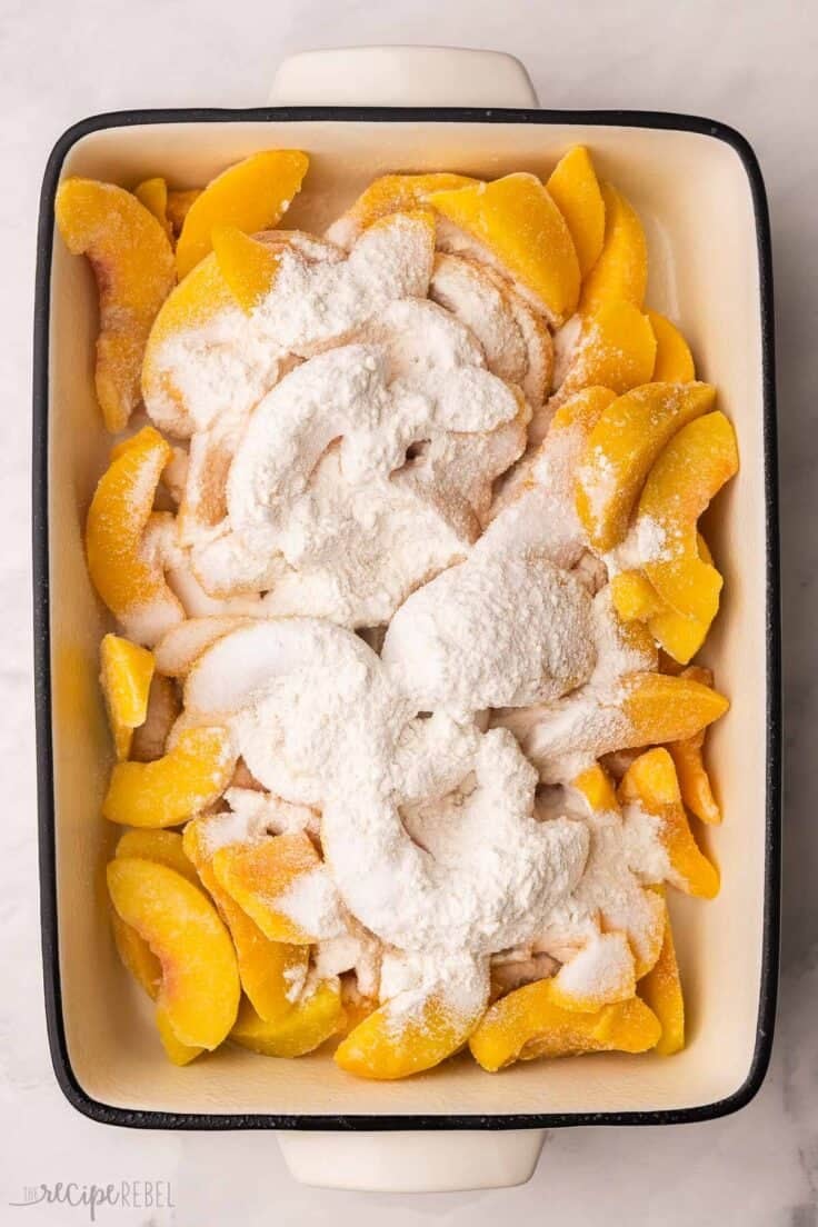 peaches in a dish with dry ingredients added.