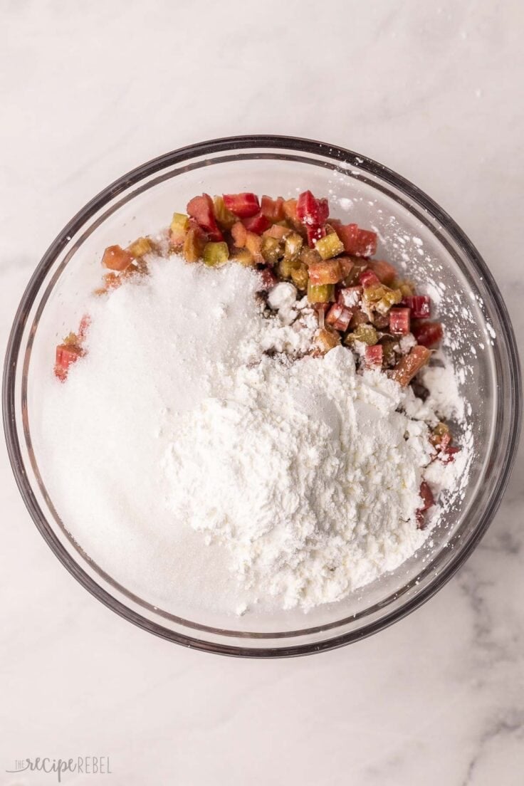 dry ingredients added to bowl of chopped rhubarb.
