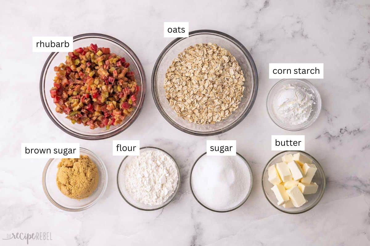 This Rhubarb Crisp recipe is packed with a tangy rhubarb filling and topped with a crunchy oatmeal streusel! Add a big scoop of vanilla ice cream on top for a sweet and tart dessert that's ready in 45 minutes. #rhubarb #dessert #recipe | dessert recipes | rhubarb recipes | rhubarb dessert | fruit crisp | baking recipe | easy recipes ingredients needed for rhubarb crisp in bowls.