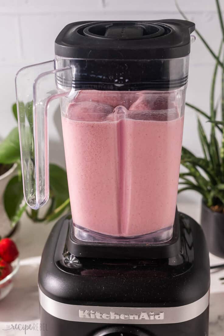 strawberry frappuccino being mixed in a blender.