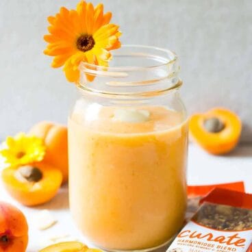 apricot almond milk smoothie in a glass.
