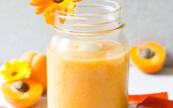 apricot almond milk smoothie in a glass.