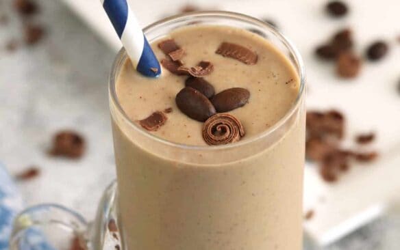 coffee smoothie in a glass with a paper straw.