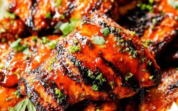honey sriracha chicken on a plate with lime wedges