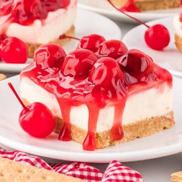 slice of no bake cherry cheesecake on a white plate.