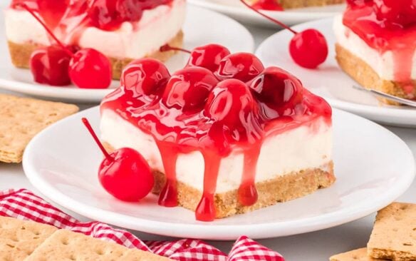 slice of no bake cherry cheesecake on a white plate.