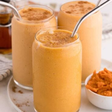 3 pumpkin pie smoothies with straws.