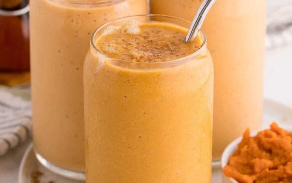 3 pumpkin pie smoothies with straws.