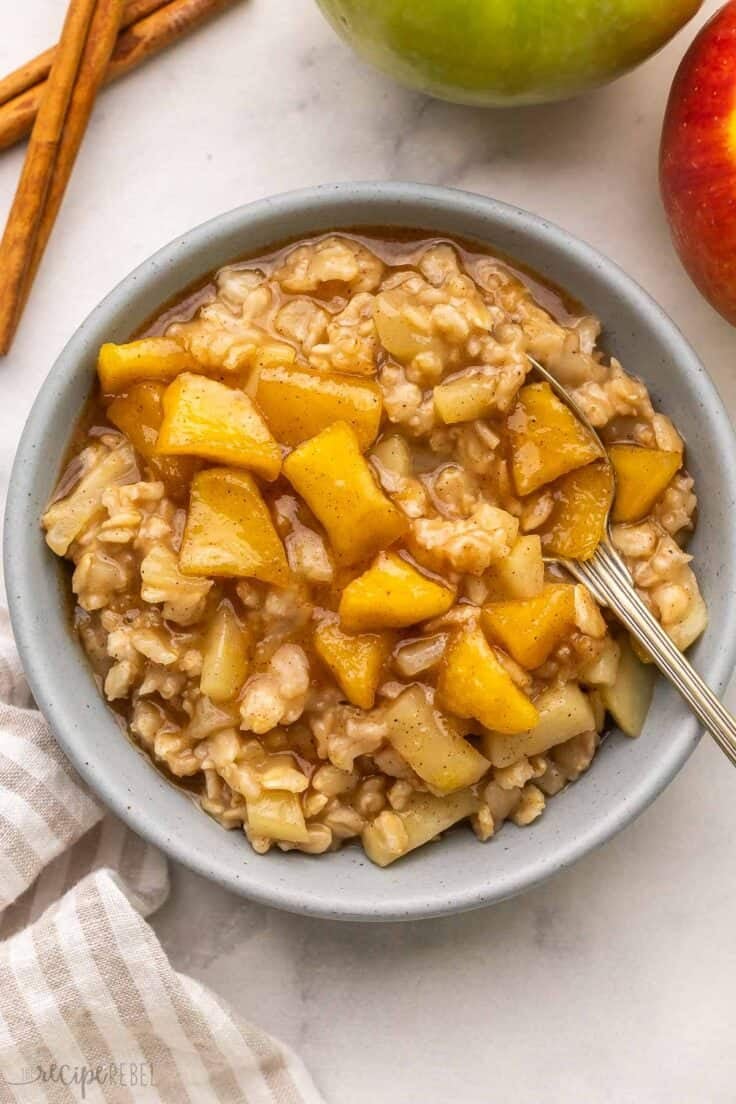 a spoon in a bowl of apple cinnamon oatmeal.