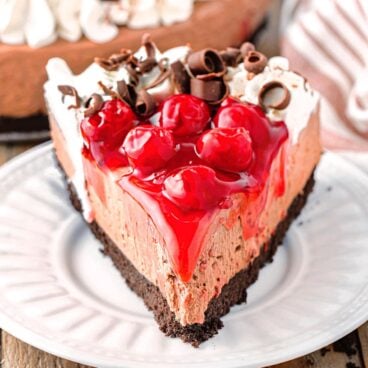 slice of no bake Black Forest cheesecake on a white plate.