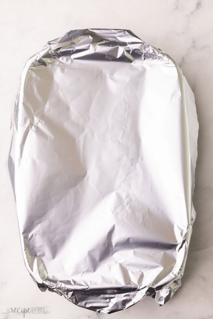 a baking dish covered in aluminum foil.