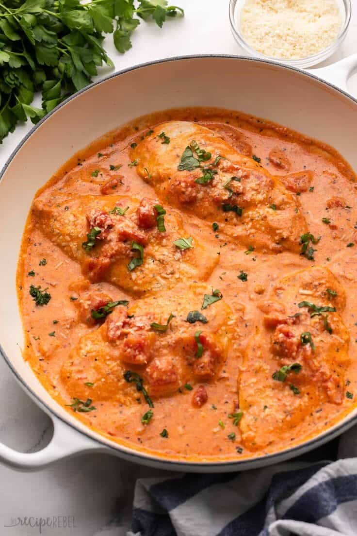 white skillet with tomato basil chicken breasts.