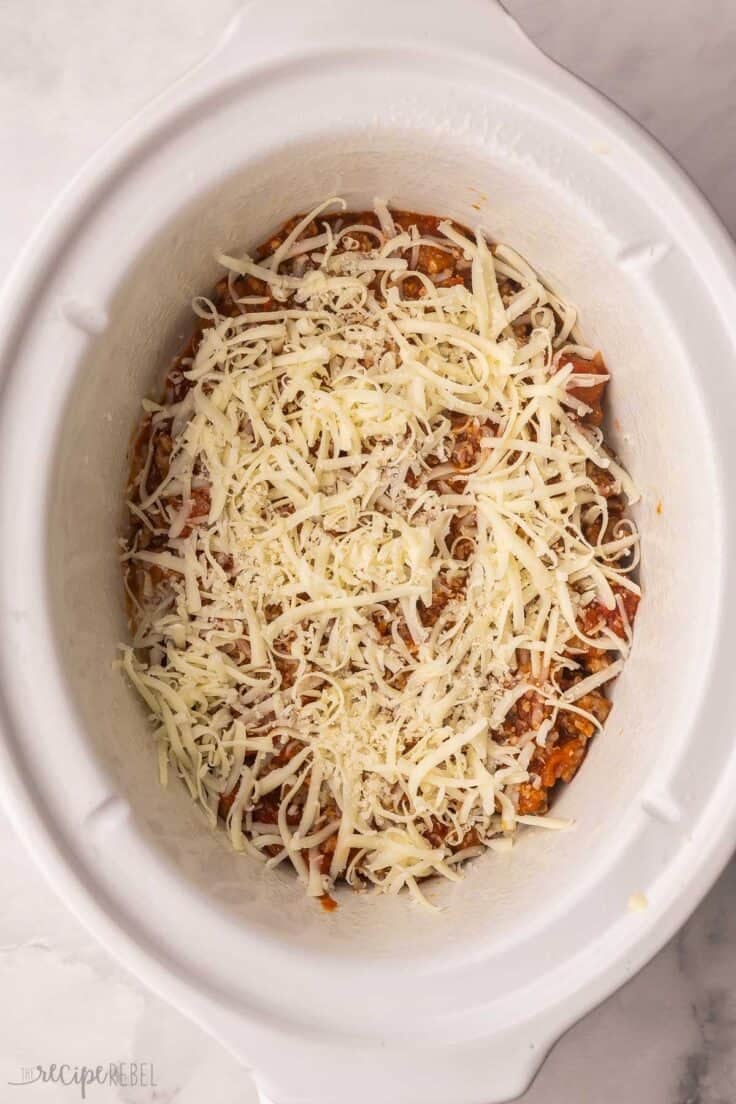 shredded cheese added to other ingredients in crockpot.