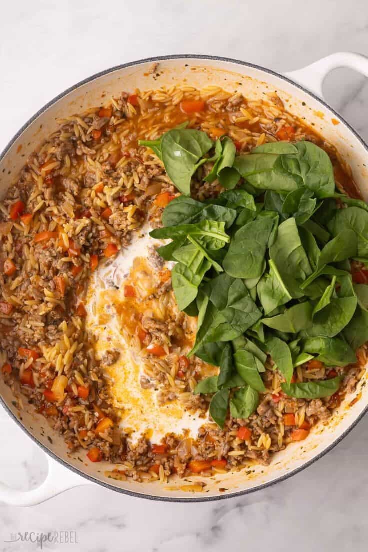 spinach added on top of other ingredients in large skillet.