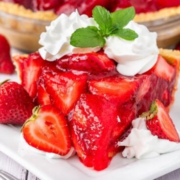 slice of fresh strawberry pie on a white plate.