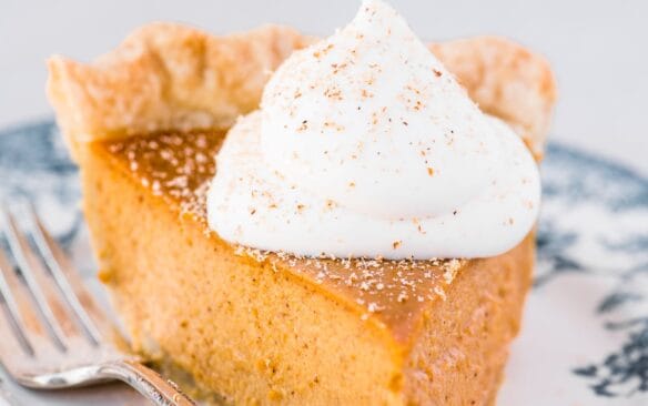 slice of pumpkin pie on a decorative plate.