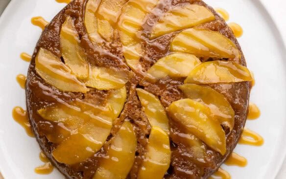 square overhead image of apple upside down cake with caramel drizzle.