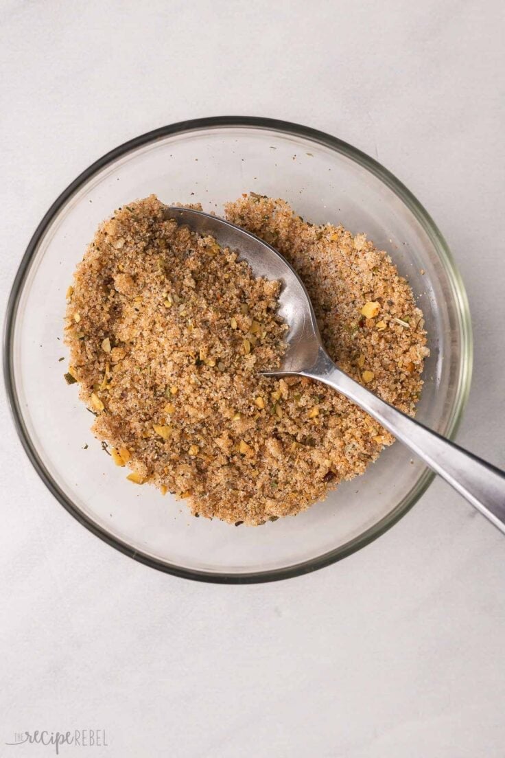 spices mixed in a small glass bowl with a spoon in it.