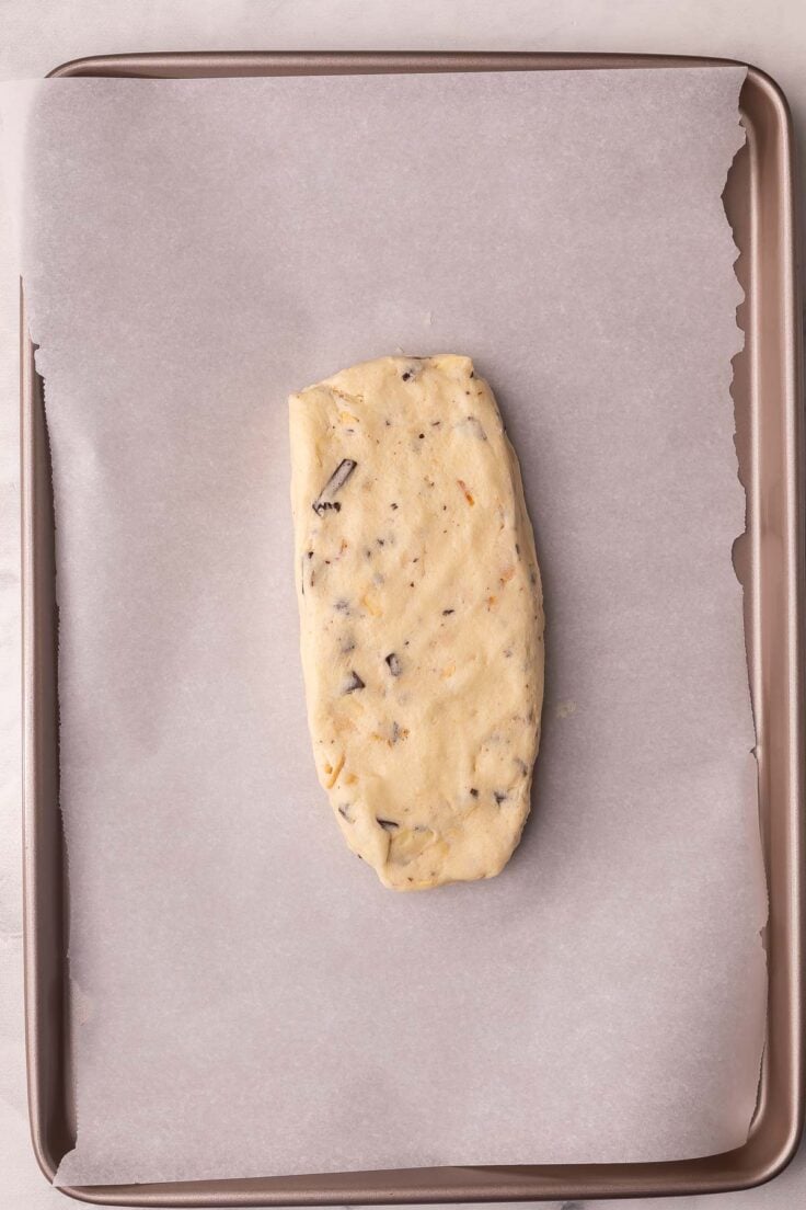 biscotti dough shaped into a rectangle on a parchment lined pan.