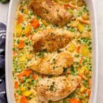 square image of chicken casserole with chicken breasts and vegetables in a creamy sauce.