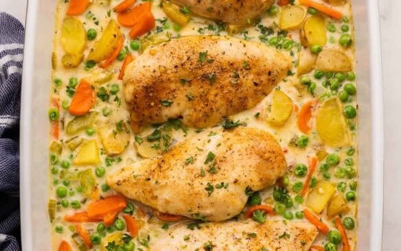 square image of chicken casserole with chicken breasts and vegetables in a creamy sauce.