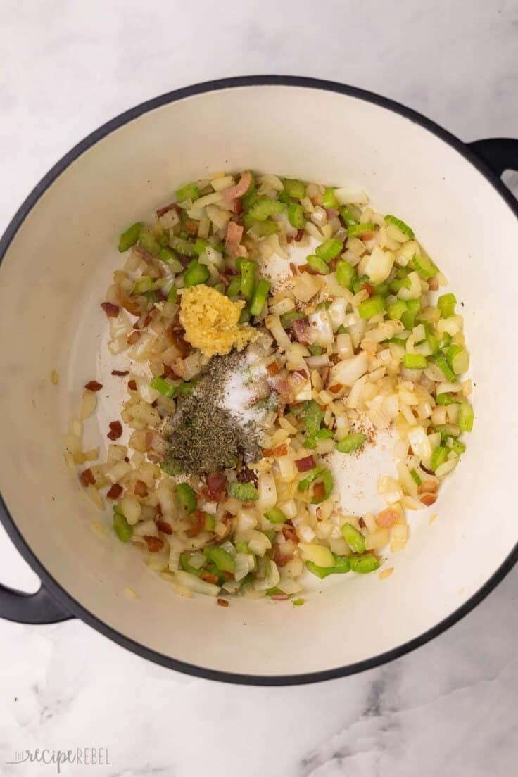 spices added to vegetables in large pot.