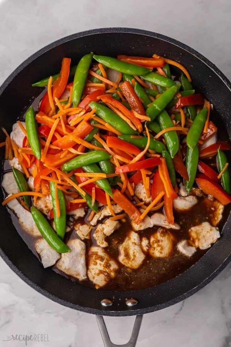 vegetables, sauce and chicken all added to black pan.