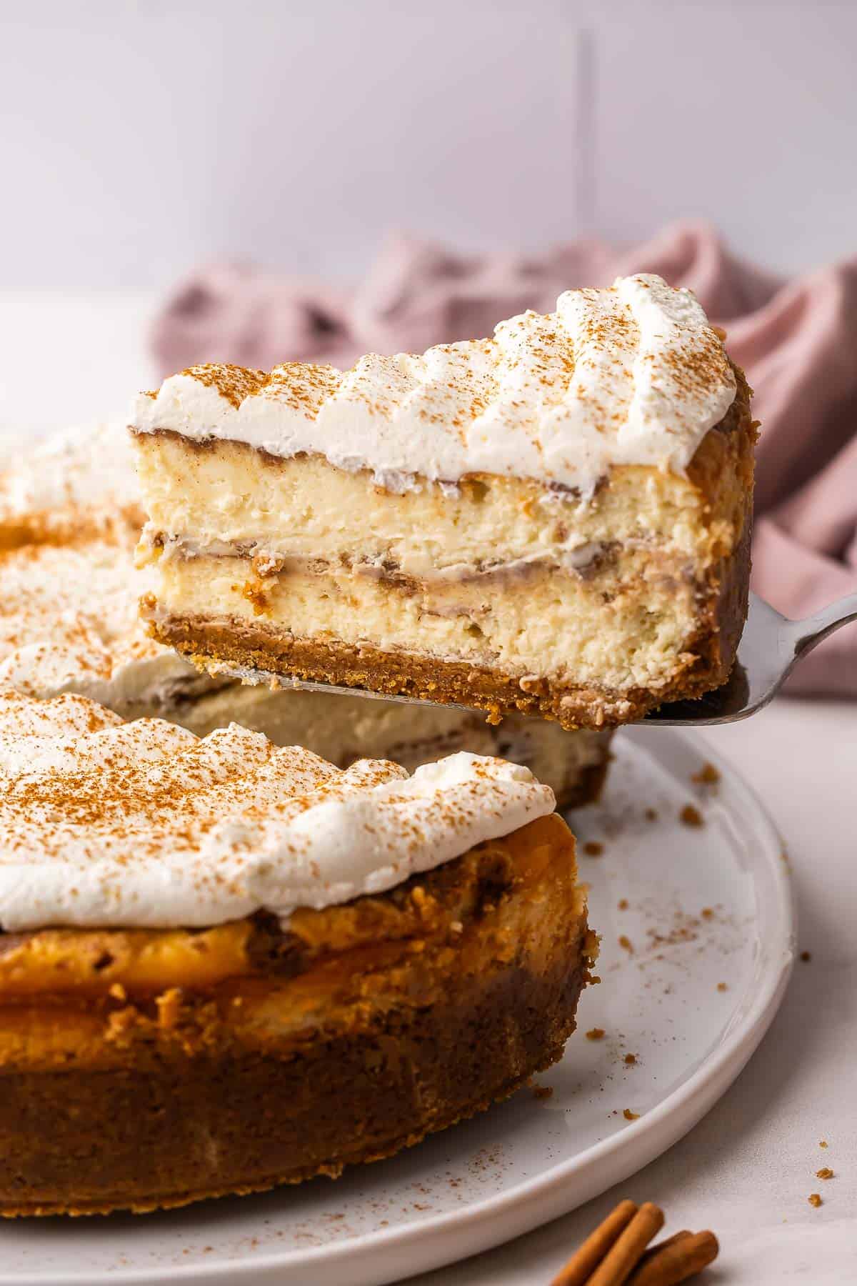 a slice of cheesecake being lifted off of plate.