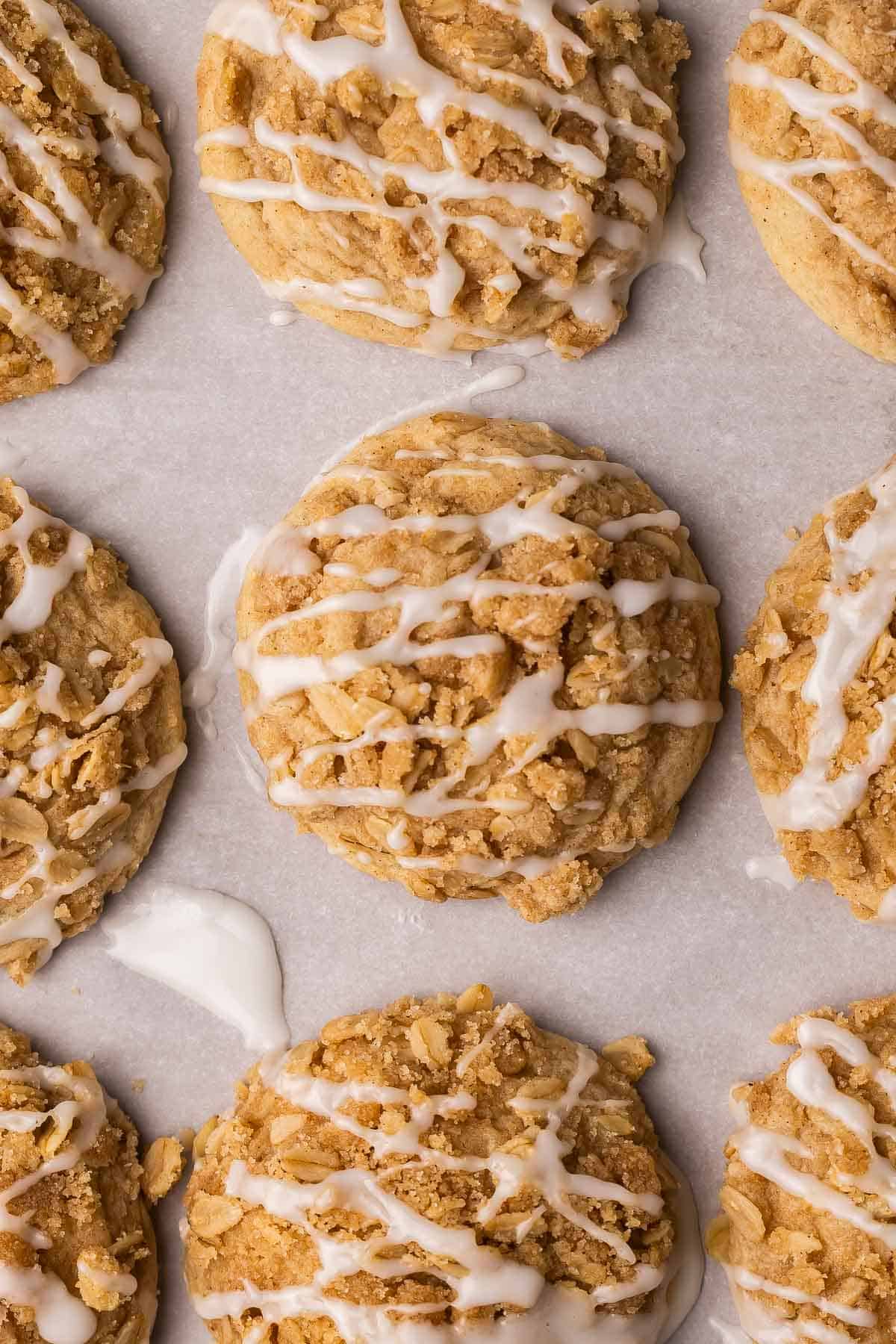 coffee cake cookies on parchment topped with glaze.
