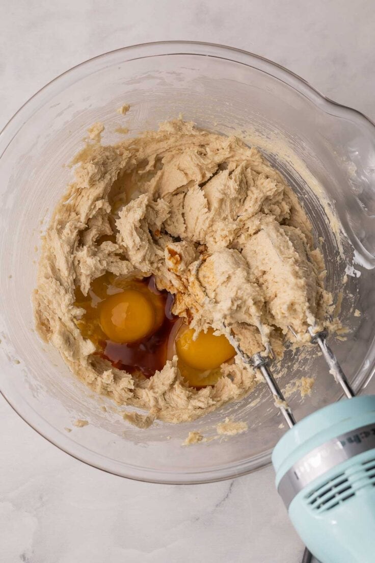 eggs added to mixing bowl with dough ingredients.