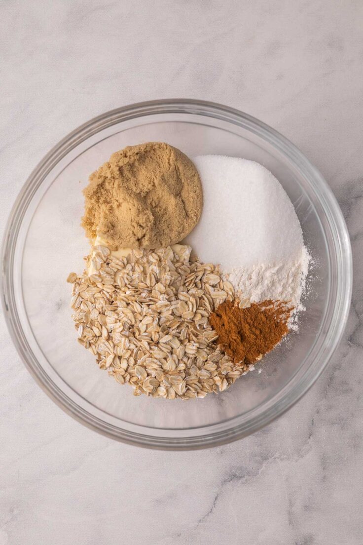 oats and other dry ingredients added to glass mixing bowl.