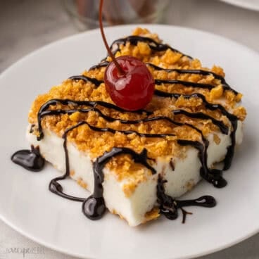 square image of fried ice cream dessert on plate with chocolate drizzle.