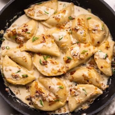 large black filled with perogies, bacon and onions.
