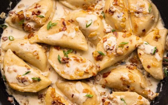 large black filled with perogies, bacon and onions.
