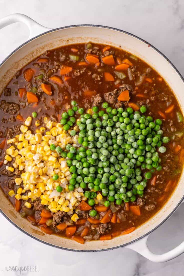 frozen vegetables added to other ingredients in skillet.