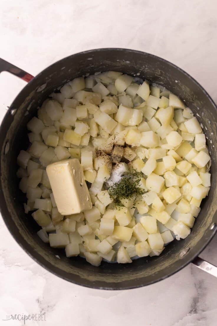 pot of cubed potatoes with butter and spices added.